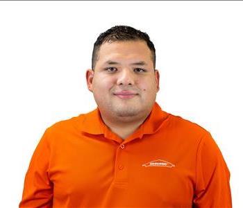 male employee with green SERVPRO background 